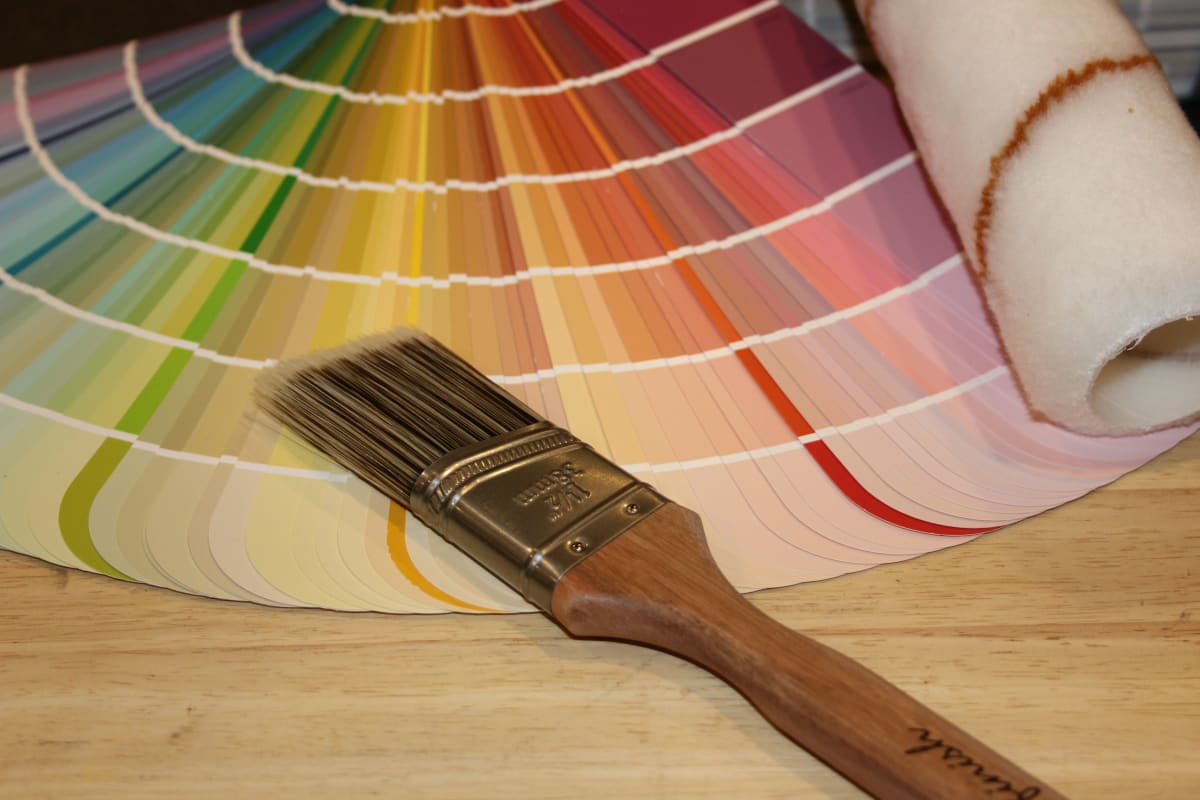 Paintbrush on a fan of color swatches