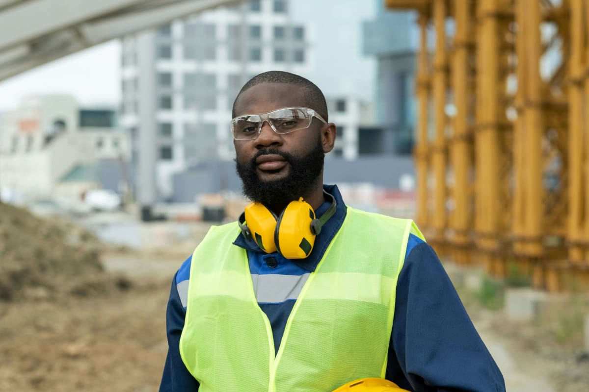 Worker in a hi-vis vest, safety glasses and earmuffs