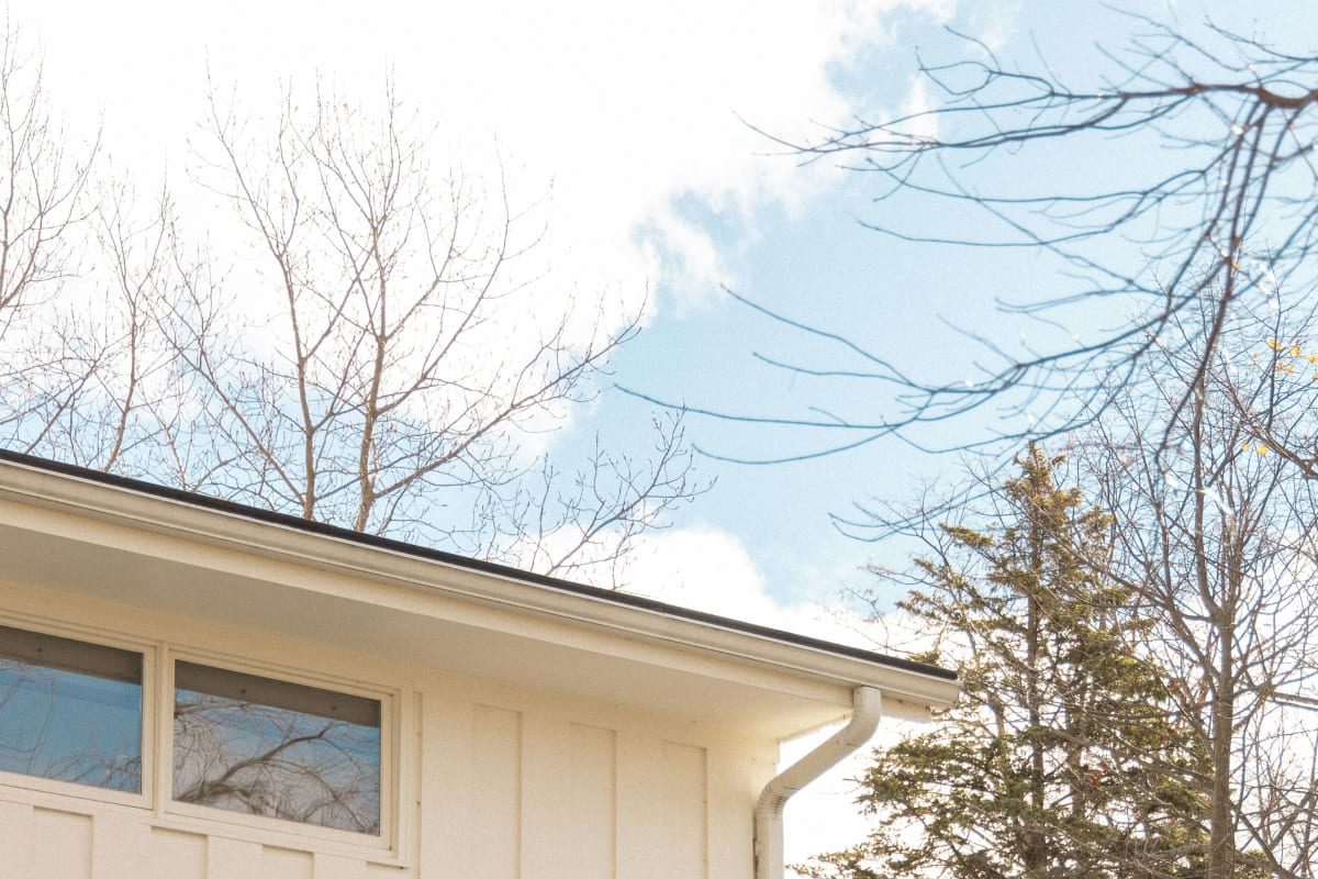 Clean soffit and gutter on a white board-and-batten home