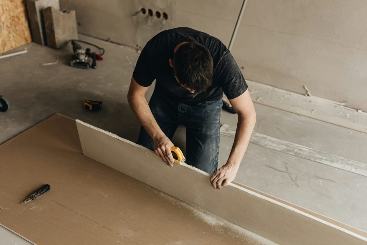 Cutting drywall to size on the floor