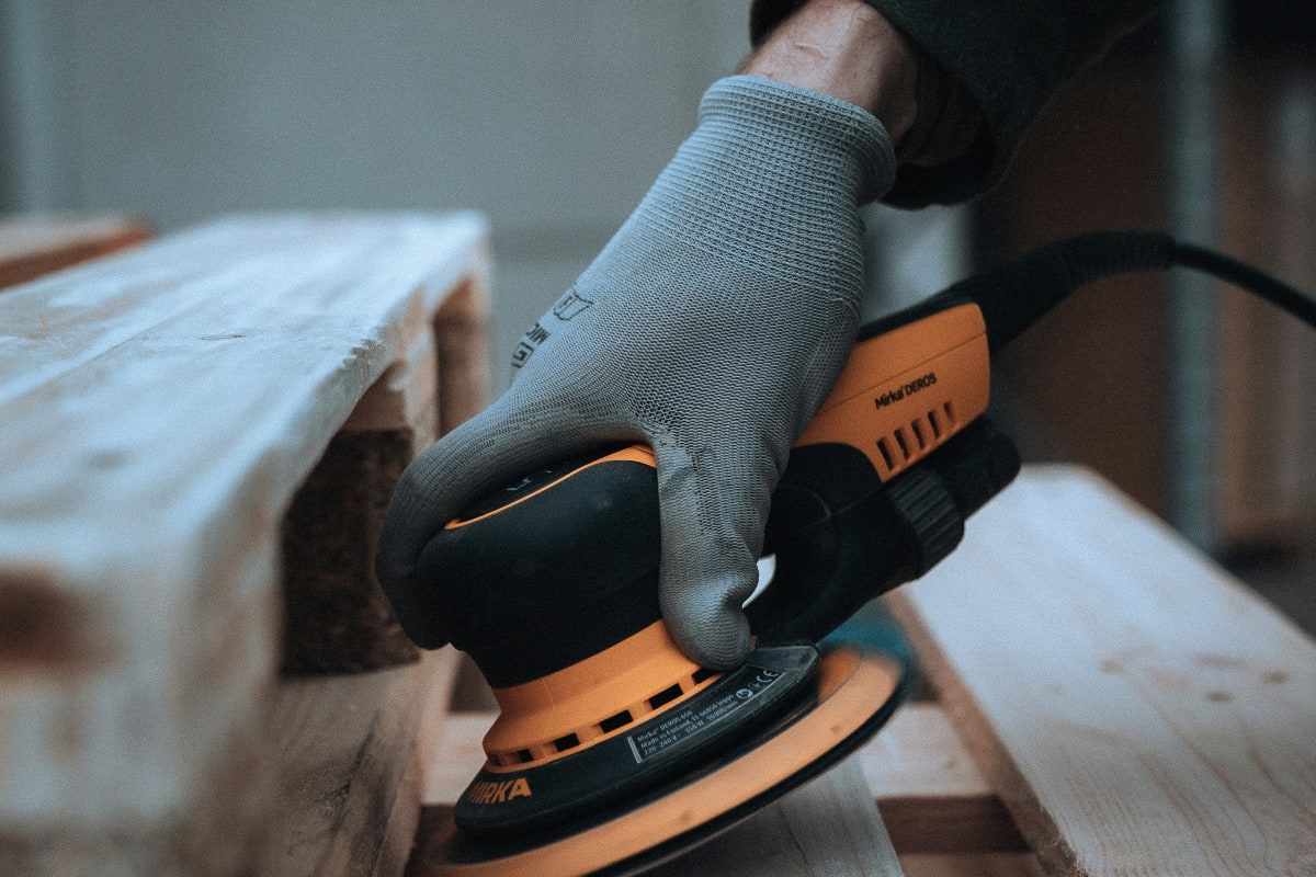 Sanding a wood bench