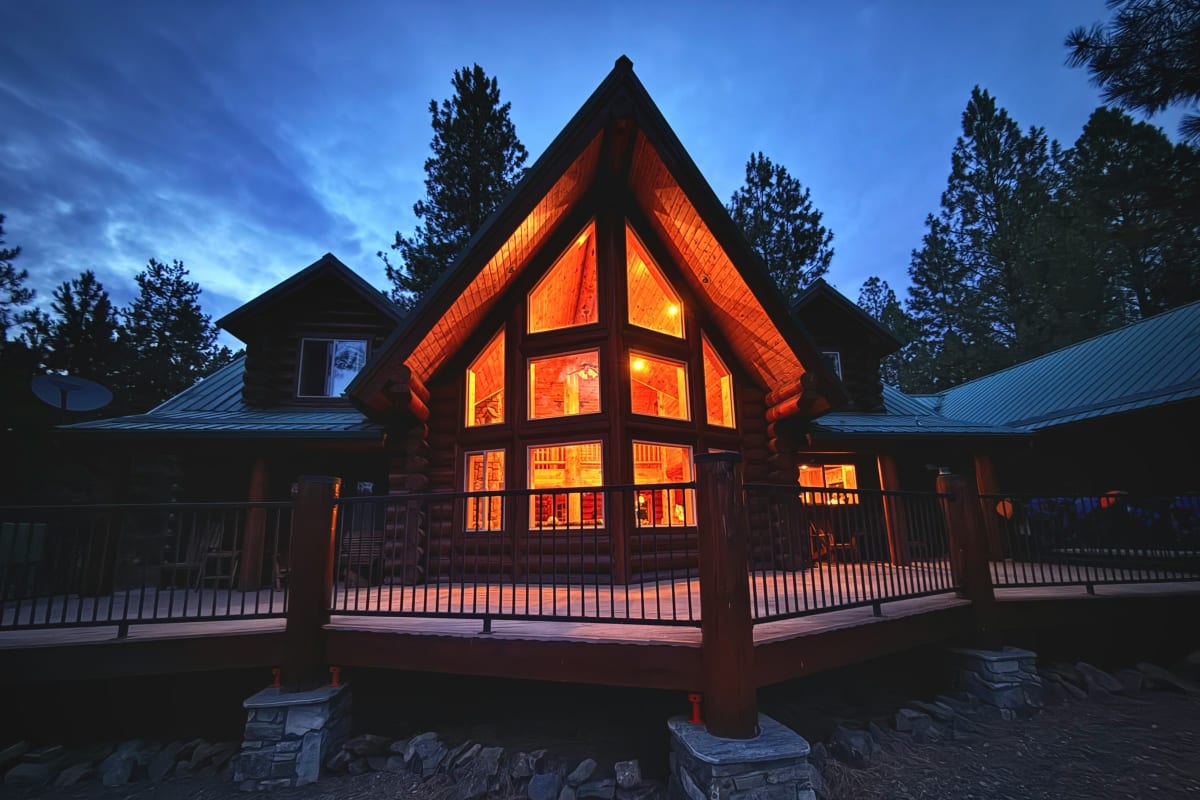 Log home glowing at dusk