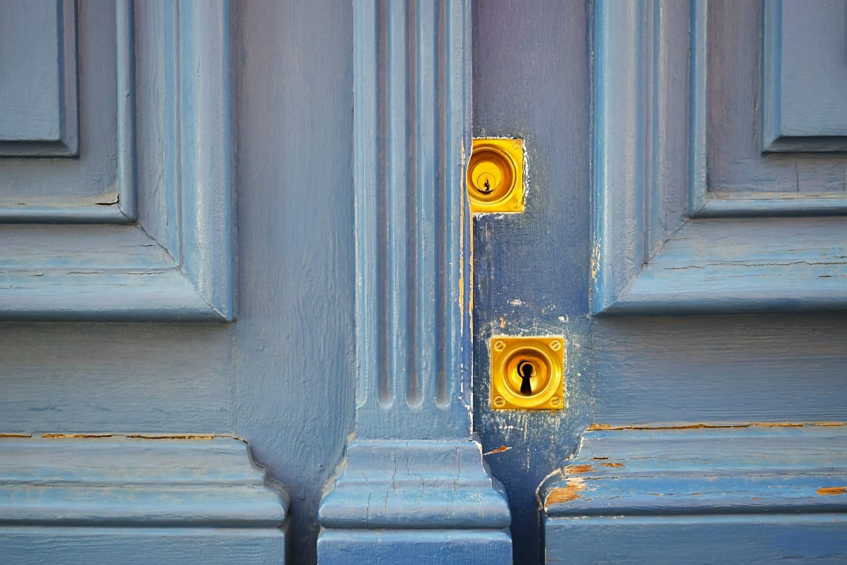 Deadbolts on a blue paneled door
