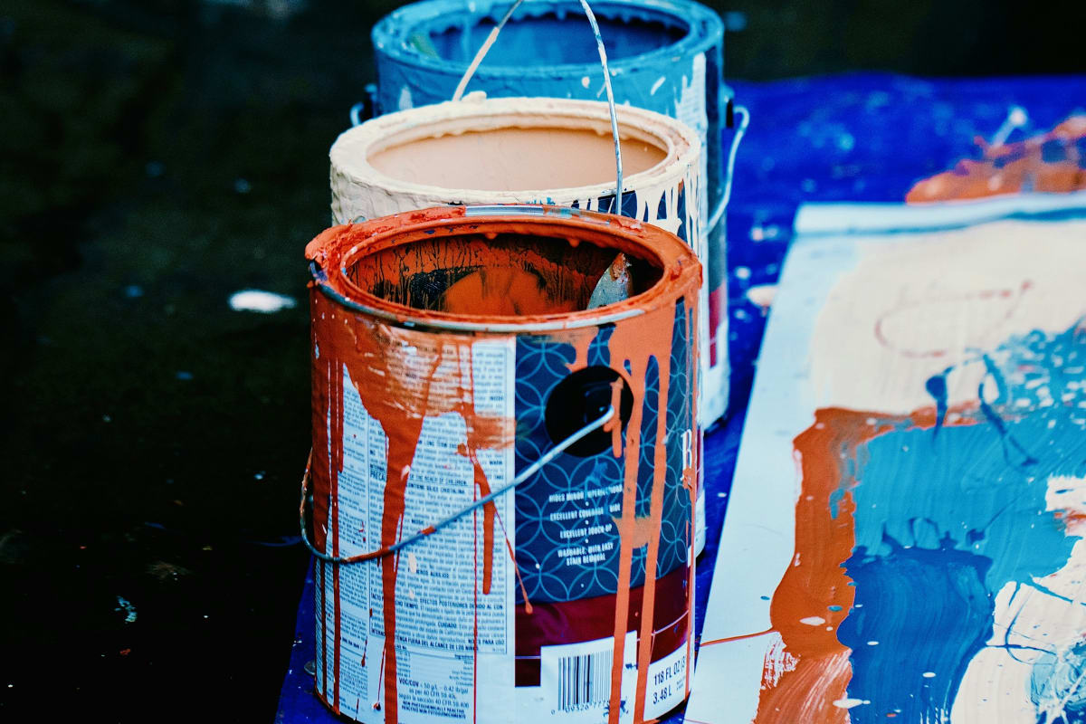 Paint cans dripping with color