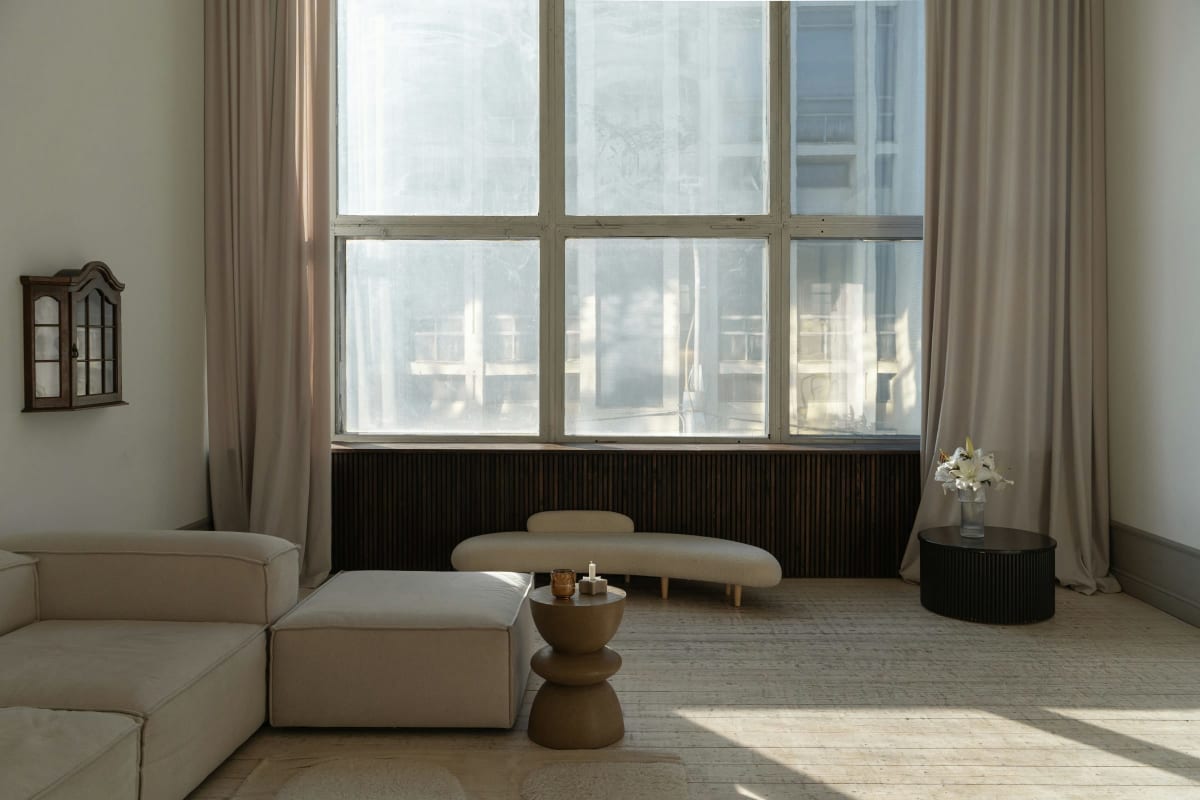Bright living room with tall windows and sheer curtains