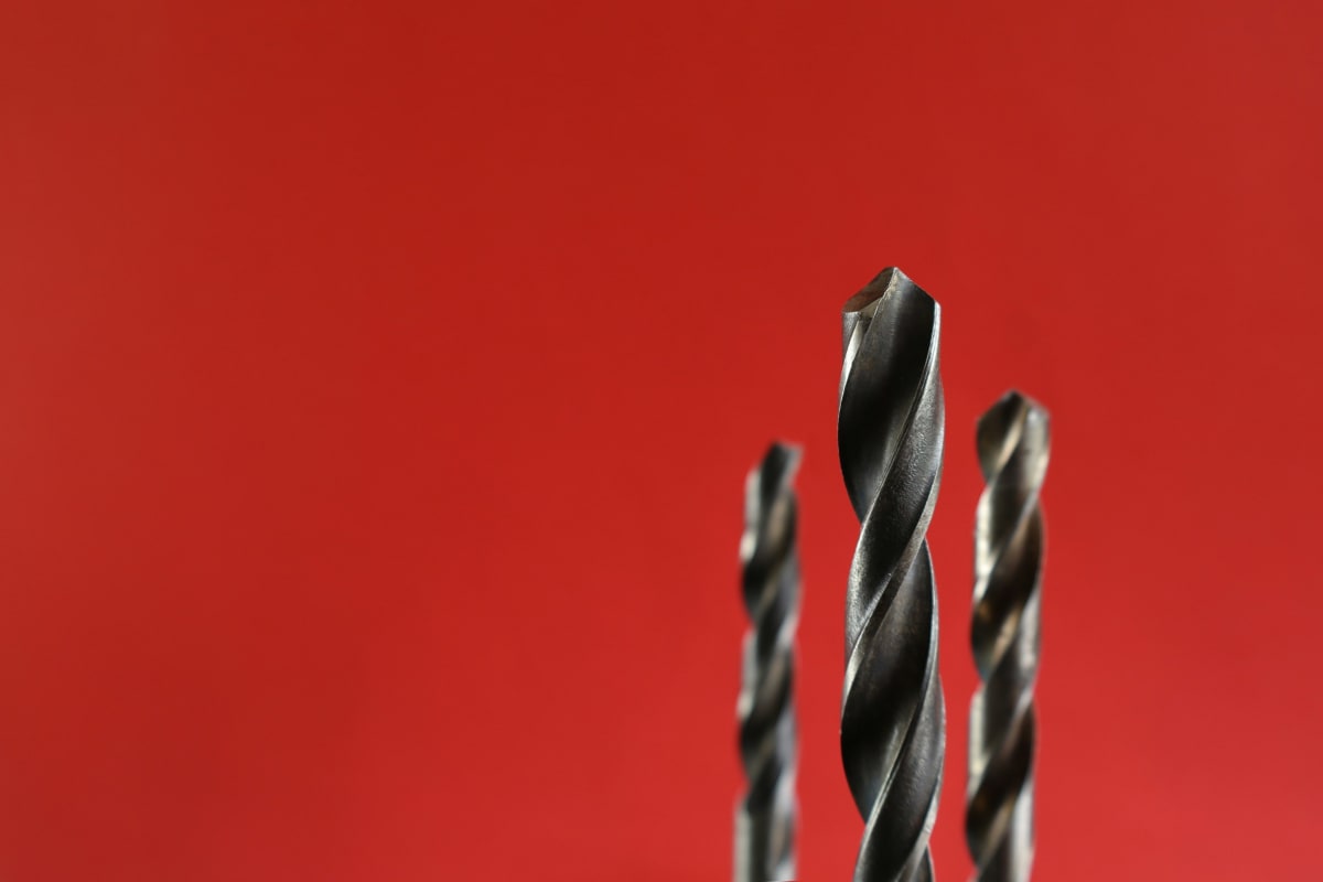 Drill bits against a red background