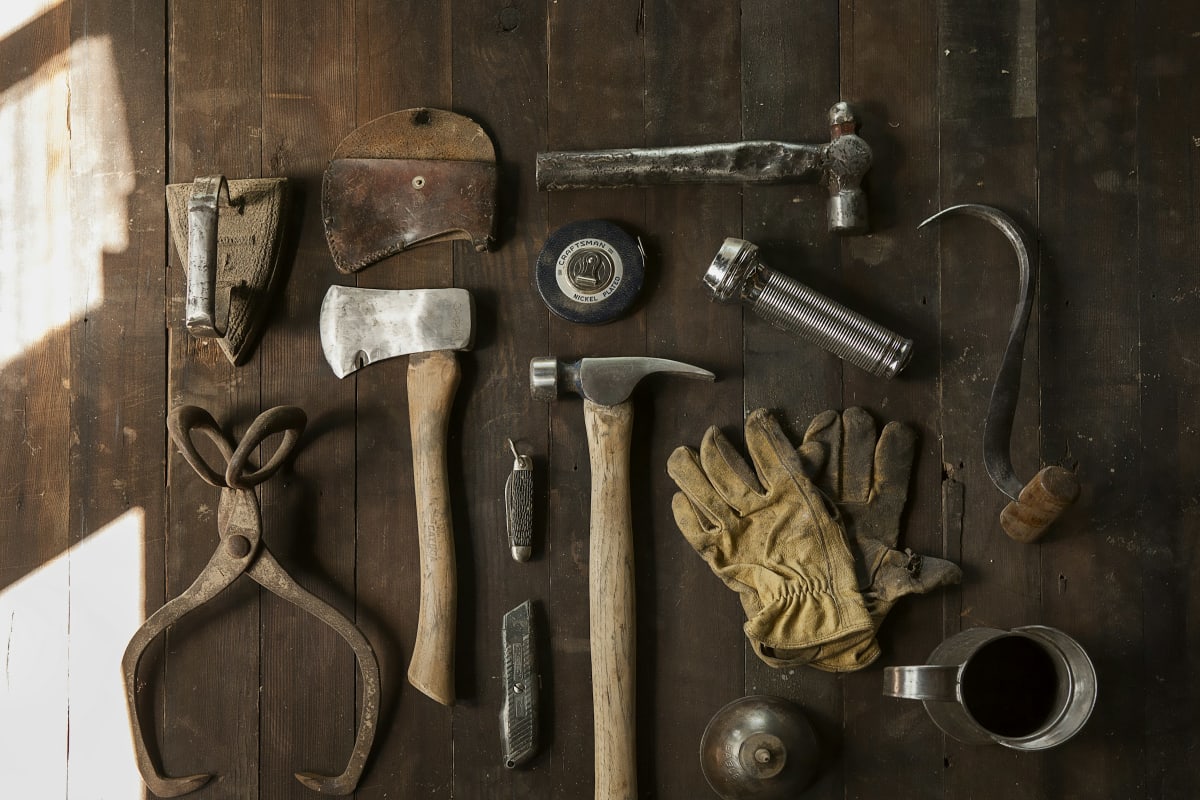 Hand tools laid out on a dark wood bench