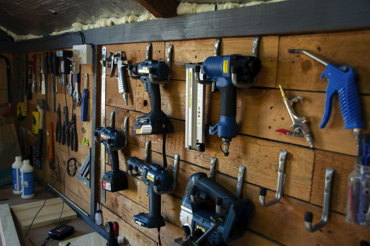 Power tools hung on a wood shop wall