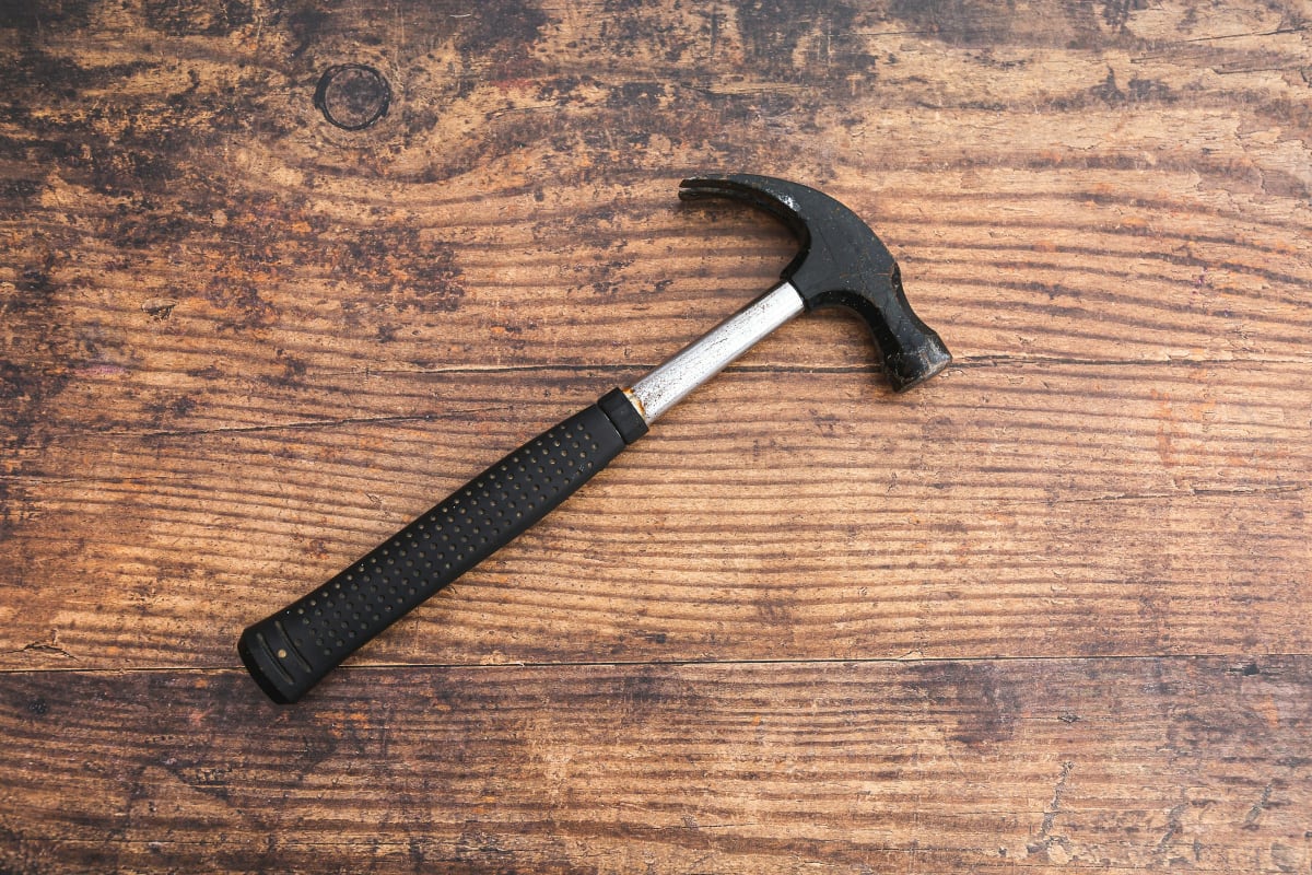Claw hammer on a weathered wood bench