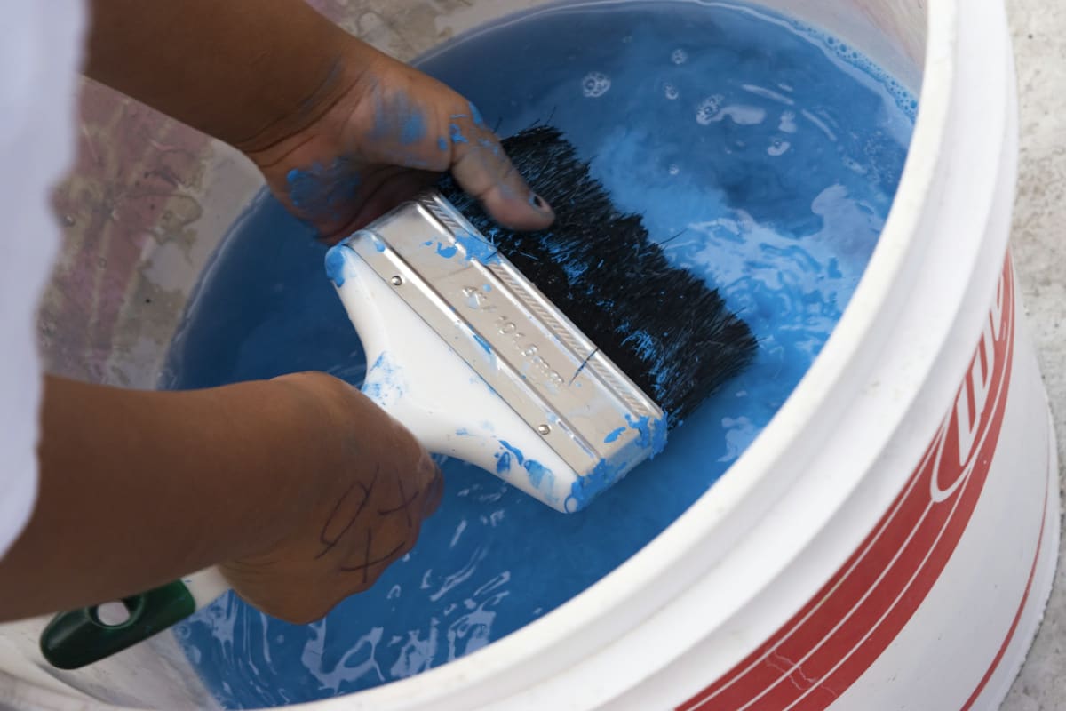 Rinsing a brush in a bucket