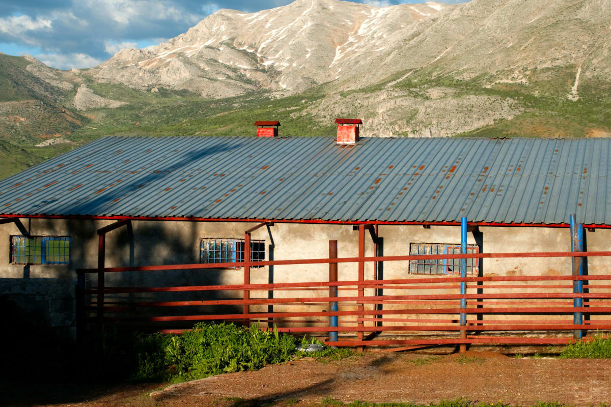 Long metal roof below the mountains