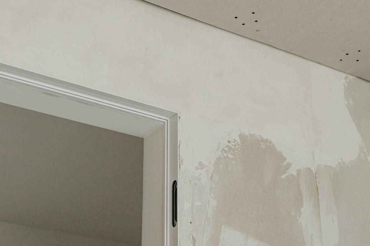 Finished drywall corners around a door opening