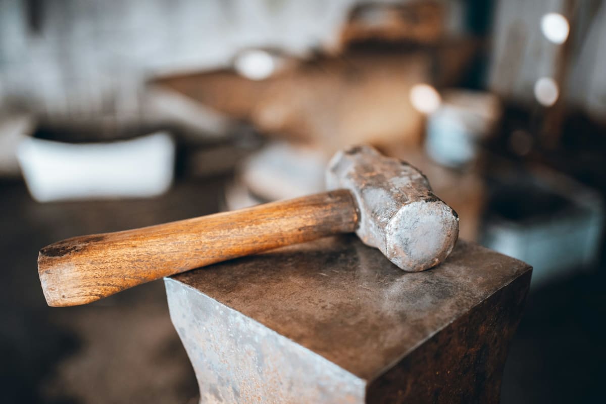 Hammer resting on an anvil