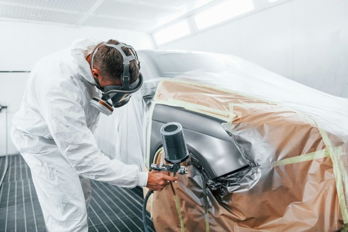Spraying paint with a spray gun