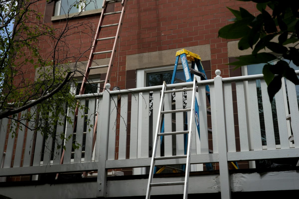 Extension ladder against a brick house