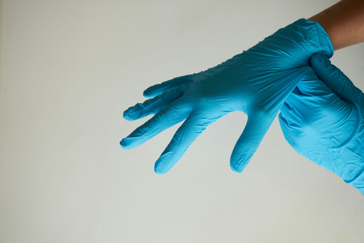 Pulling on a pair of nitrile gloves