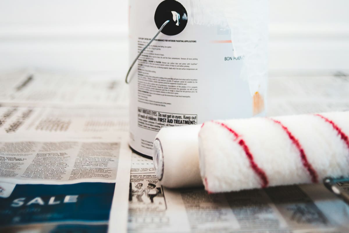 Paint can and roller on a drop cloth