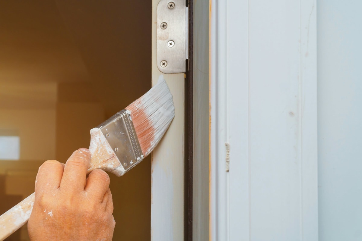 Brushing primer onto a door frame