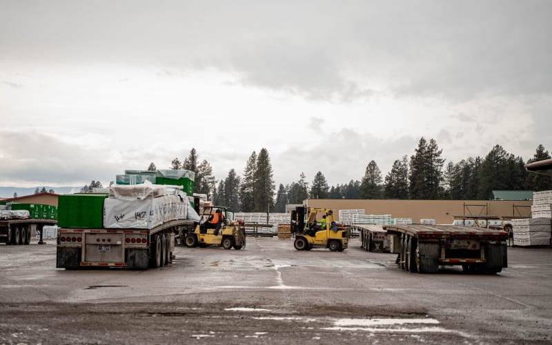 WBC corporate yard with semi-trucks and forklifts moving building materials