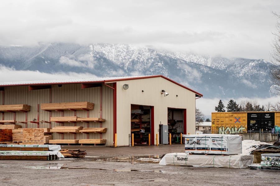 Western Building Center Kalispell lumber yard with snow-capped mountains