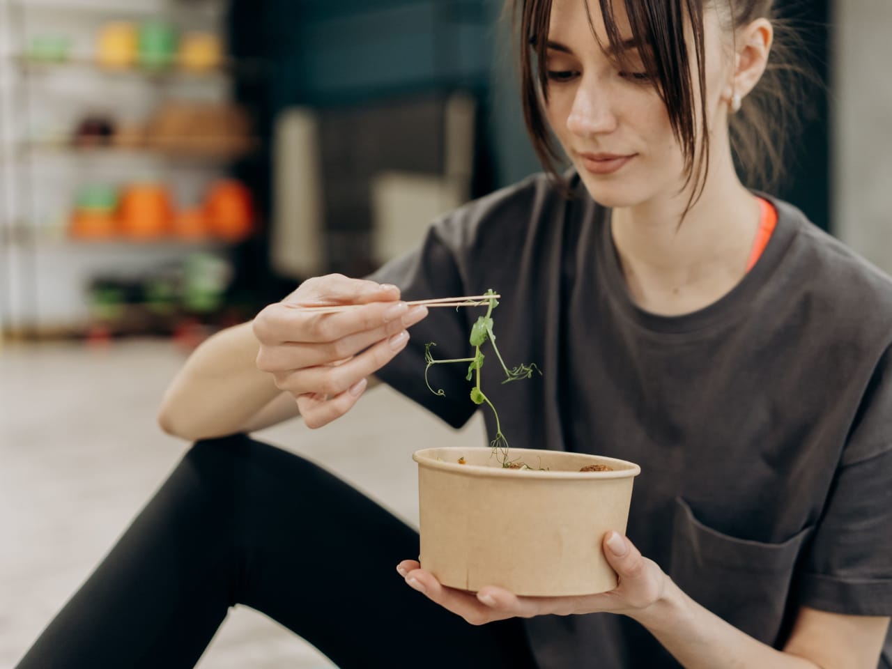 Young woman enjoying a healthy salad bowl