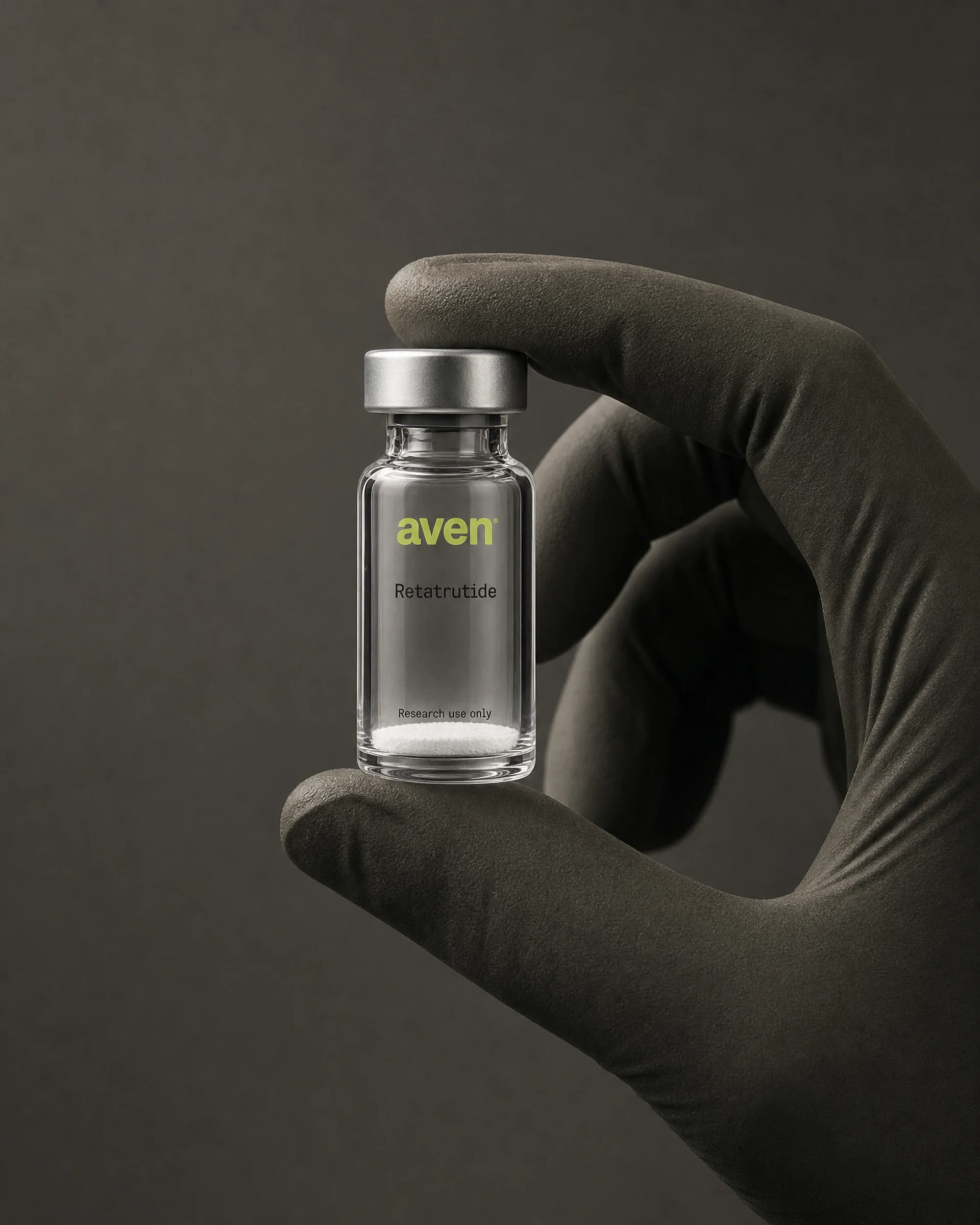 A gloved hand holding a sealed vial