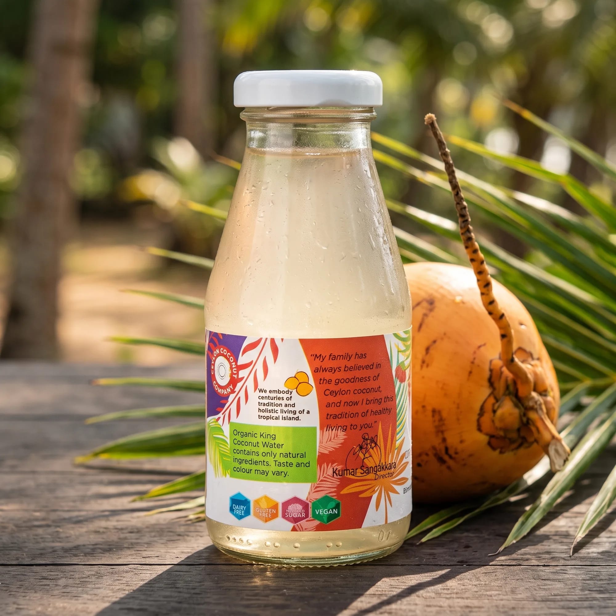 King Coconut Water 200ml bottle with fresh king coconuts and palm leaves — made in Sri Lanka, from Agromel UK