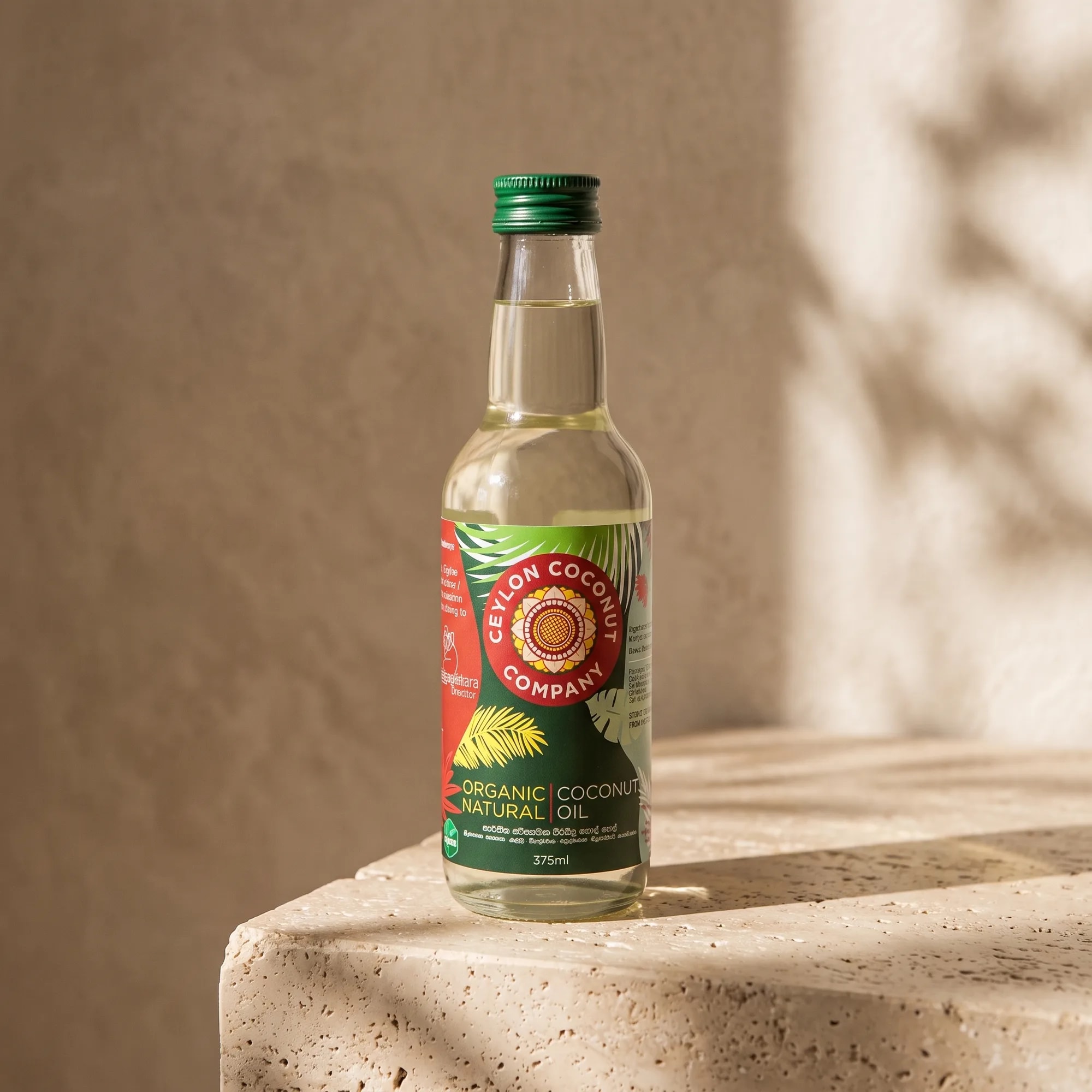 Organic Natural Coconut Oil 375ml bottle in a soft-lit studio setting — made in Sri Lanka, from Agromel UK