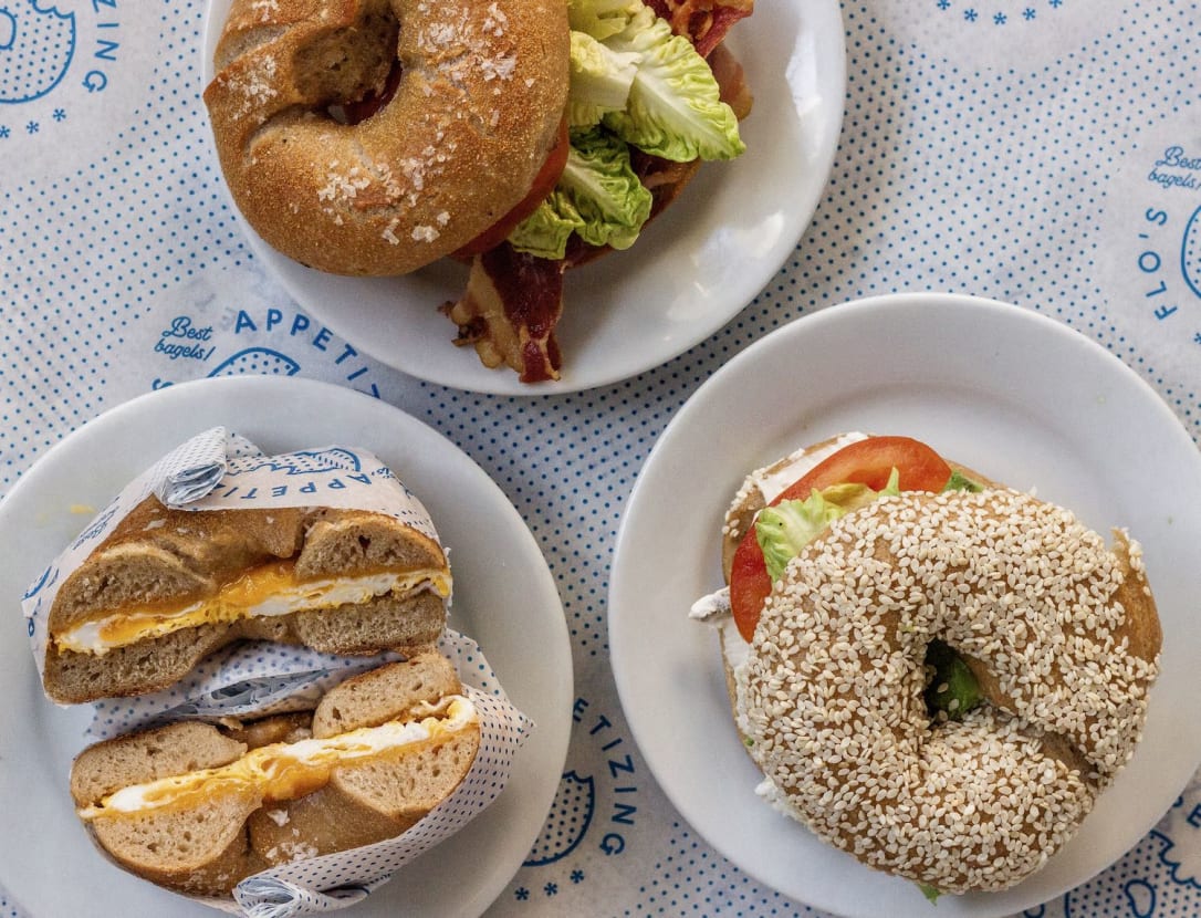 Plates of delicious bagels for best Amsterdam breakfast or lunch. Article by Table Sage