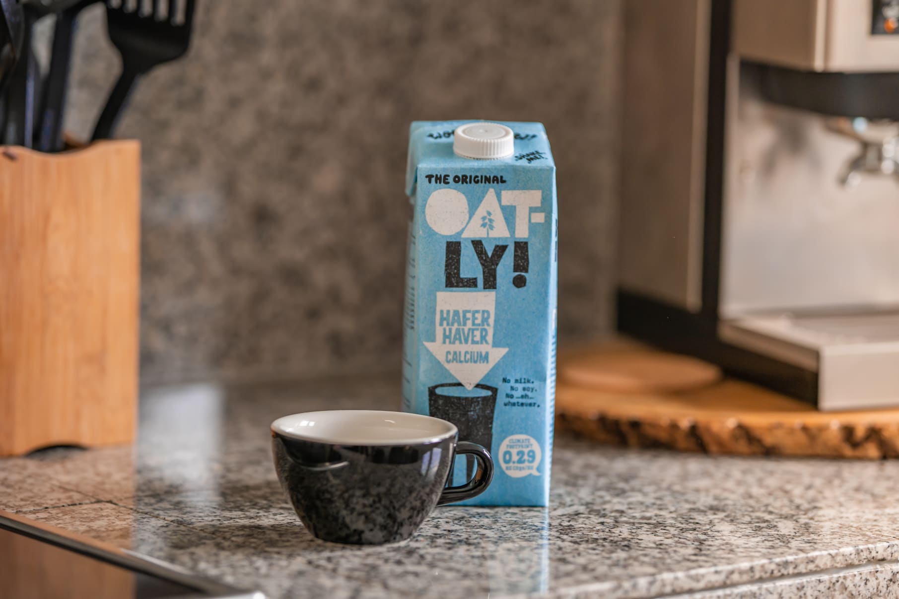 Personal review of Oatly oat milk. Pictured- a carton of Oatly on a kitchen counter