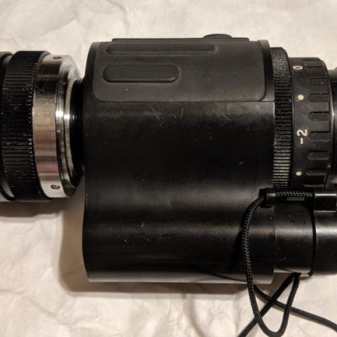 ENVIS M703E night vision monocular, Gen 3 tube (no idea what specs, but can provide through the tube photos). One tiny blem that's hard to notice unless you're looking for it. Lens is a Computer 50mm f1.3 lens (acts as a 2x magnifier, the ENVIS uses C-Mount/CCTV lenses which are dirt cheap and easy to swap out). Extremely low hours, it's only had an hour or two on it (I was going to do a Mod3b housing swap, but ended up with another device). Battery housing and battery cap are pristine.