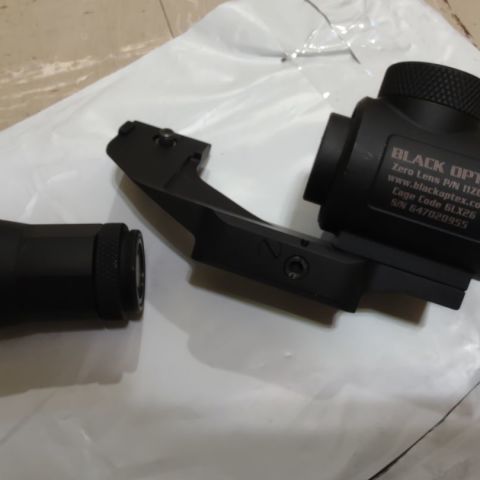 Black Optex Zero Lens for PVS-14. Mounts in front of a day optic like a poor man's PVS-24. Allows zeroing of the the PVS-14 so you don't have to rezero your day optic. Comes with a mini 3X magnifier for the PVS-14. Its a neat system, but unfortunately won't work with my ABNV Pitbull housing. Has one small ding on the aluminum housing, but is in excellent condition otherwise. 