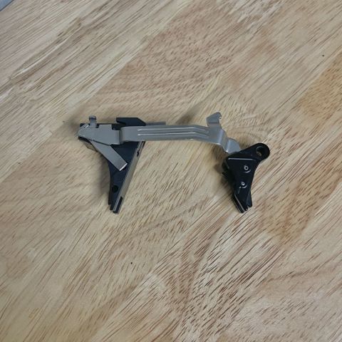 Overwatch TAC Trigger. Fits full size Gen 5 frames, G17, G19, G19X, G23, G26, G34, G45. It is like new, installed and put a mag through it.