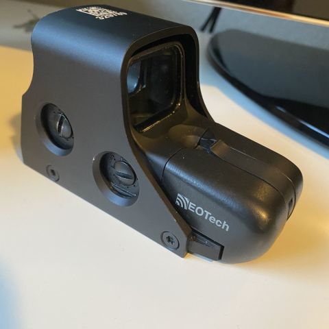 Eotech 551. Hood was lasered with the serial number to mimic mil unit. Bright reticle 