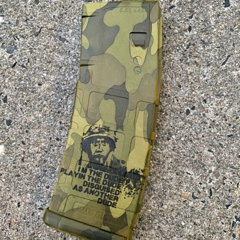 Laser Engraved Magpul Pmag in a tropic camo with Kirk Lazarus graphic. These are engraved on all sides with graphic on both. 
