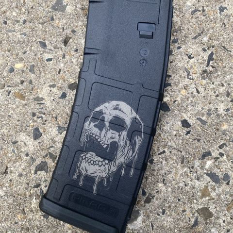 Laser engraved drippy skull magpul Pmag. This is done on both sides and the skull is facing forward on both sides for a clean look. Comes resealed in original packaging. 