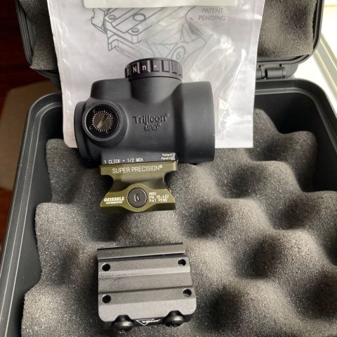 Trijicon MRO Green 2 MOA Green Dot on Geissele ODG MRO Mount.  Used two range sessions but going back to all Eotech on all my AR Platforms.  Comes with factory case, foam and low mount as well.