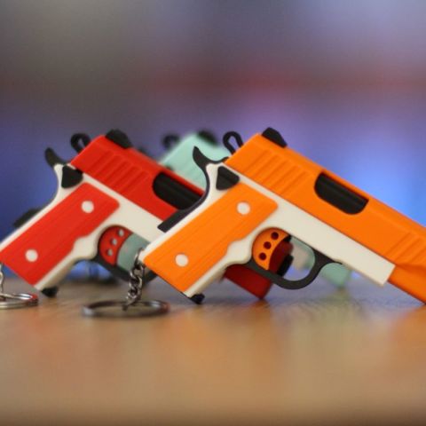 Pistol key chain and holster