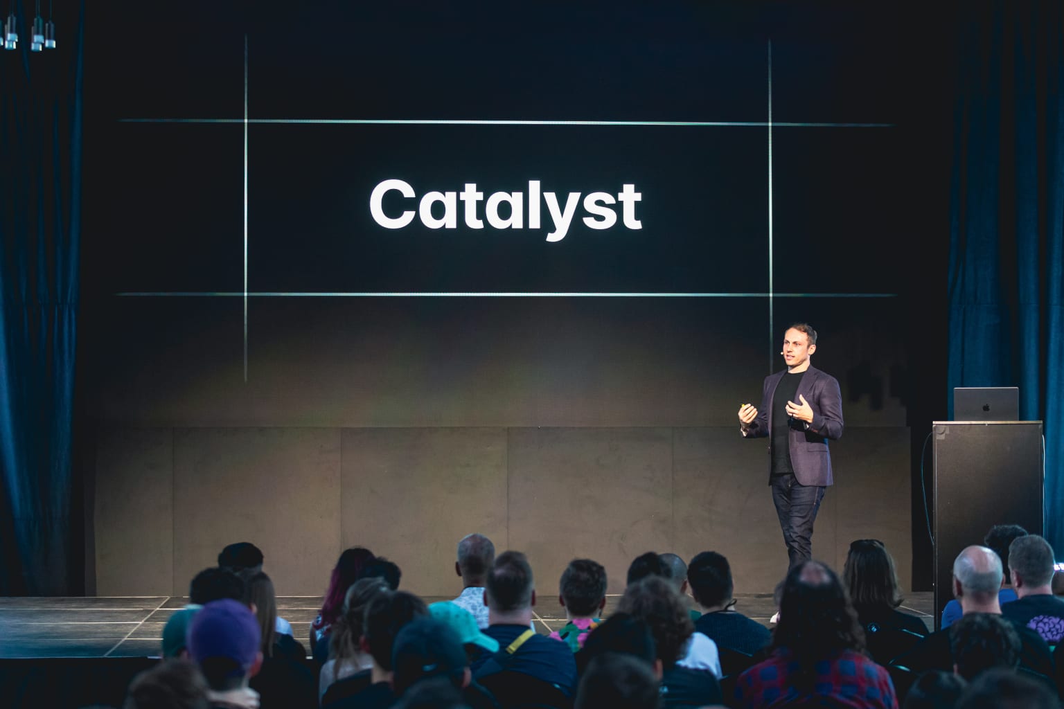 Adam Wathan on stage in front of a slide that says "Catalyst"