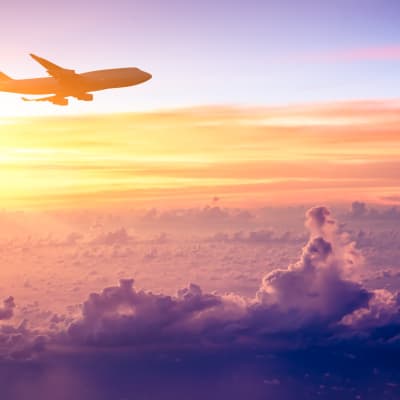 A airplane above the clouds at sunset