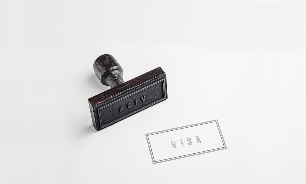A rubber stamp with the text 'ADVIS' next to a shipping label indicating 'VISA'.
