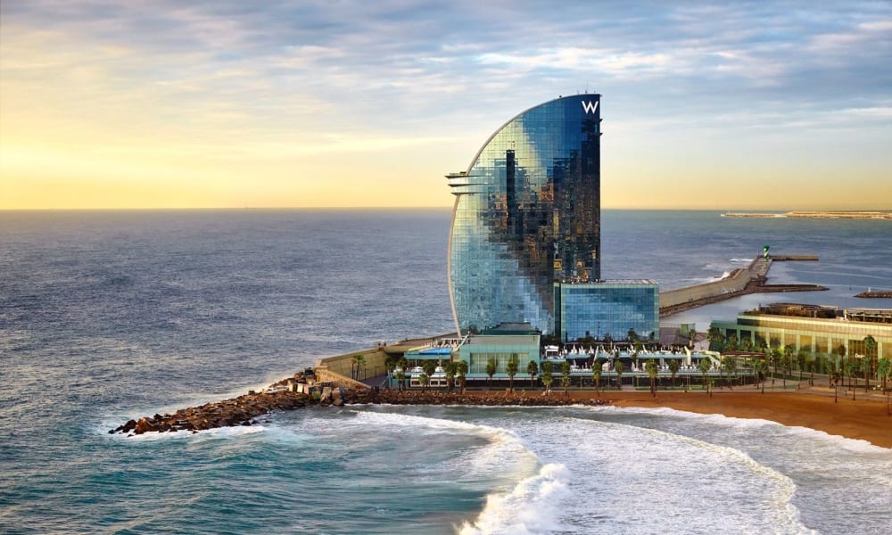 Panoramic view of the W Hotel in Barcelona with its beachfront location and modern architecture.