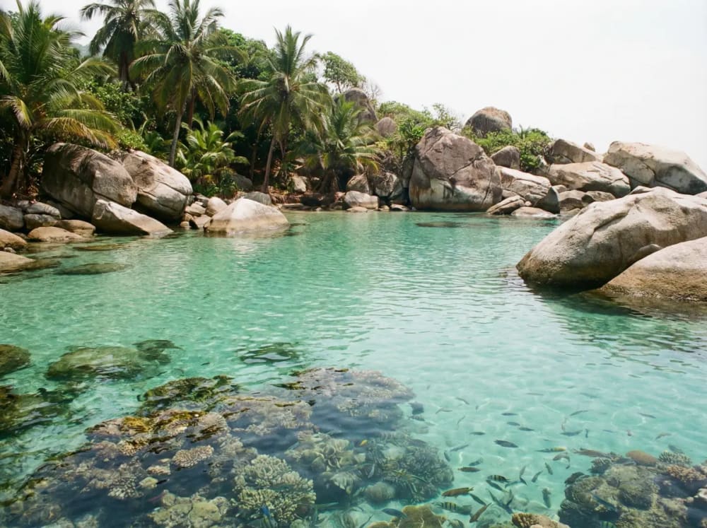 La Piscina im Tayrona Nationalpark — ruhige Lagune mit klarem Wasser hinter Korallenriff