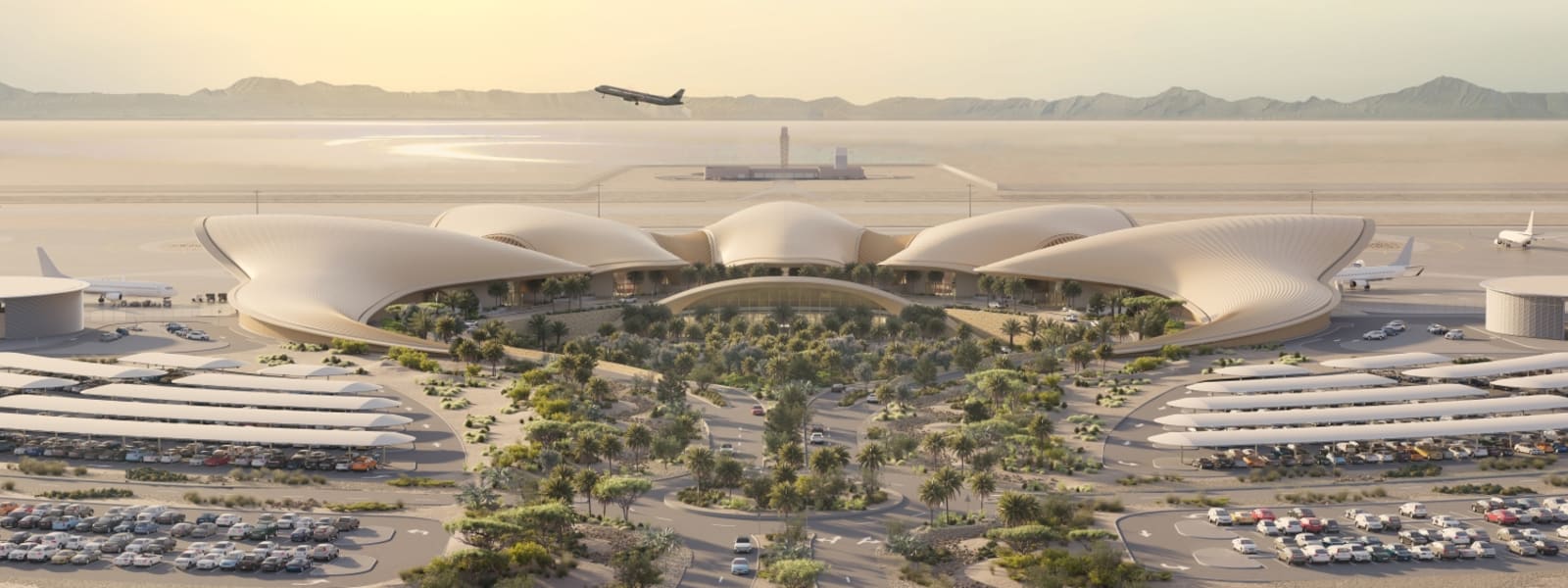 Ein großes, modernes Flughafenterminal mit großem Parkplatz und grüner Landschaft davor, in einer Wüstenumgebung mit einem Flugzeug im Flug über dem Flughafen.