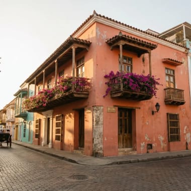Bunte Kolonialfassaden mit blühendem Bougainvillea in Cartagenas UNESCO-geschützter Altstadt im warmen Licht der Abendsonne
