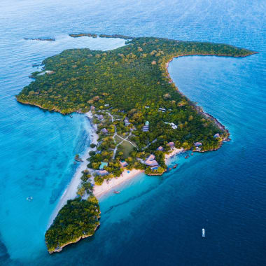 Aerial view of Azura Quilalea Private Island with lush greenery, white sandy beaches, and surrounding blue waters.