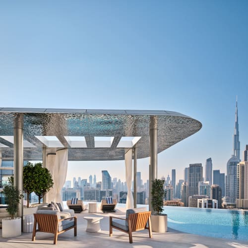 A luxurious rooftop lounge with modern furniture and cityscape views in Dubai.