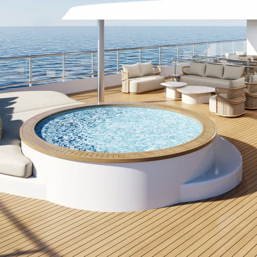 Modern yacht deck with a round whirlpool tub surrounded by a curved sofa with cushions, overlooking the ocean under clear skies.