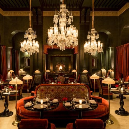Luxuriöses traditionelles Restaurant-Innere mit Kronleuchtern, bequemen Sitzgelegenheiten und warmem Licht.