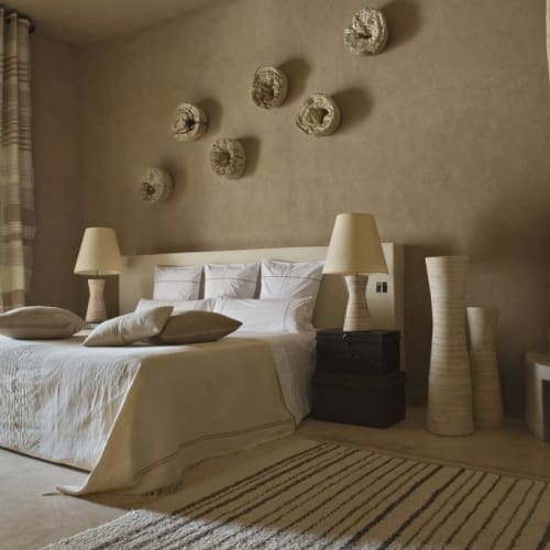 Ein gemütliches Hotelzimmer mit großem Bett, dekorativer Wandkunst und Kamin.